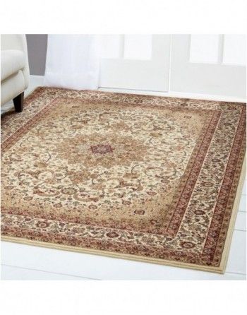 A rug is sitting on the floor in a living room next to a couch.