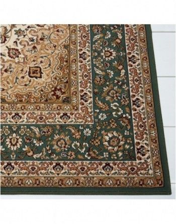 A green rug with a floral pattern on it