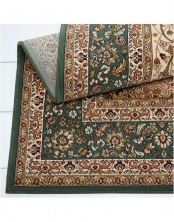 A green rug with a floral pattern on it