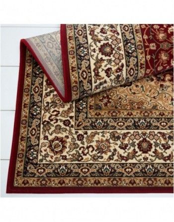 A rug with a red border is laying on a table.