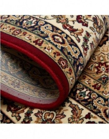 A close up of a rug with a red border