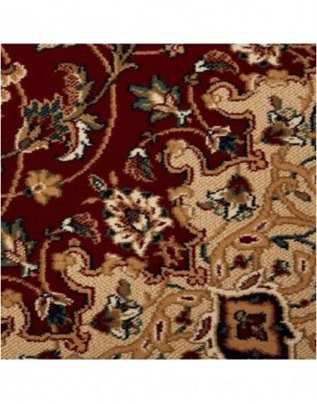 A red rug with a floral pattern on it