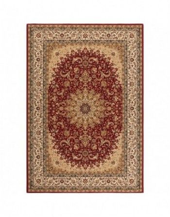 A red and tan rug with a circular pattern on it.