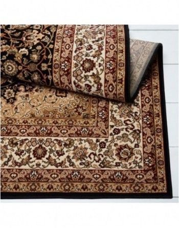 A rug with a floral pattern and a black border