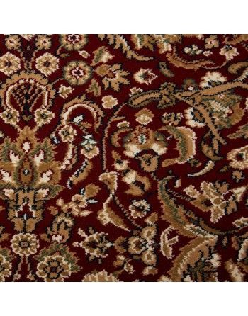 A close up of a red rug with a floral pattern.