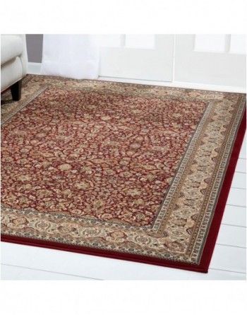 A red rug is sitting on a white floor in a living room.