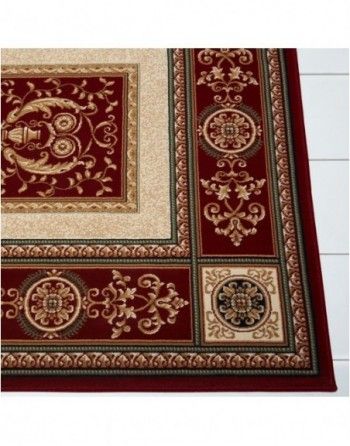 A red and gold rug with a floral design on it