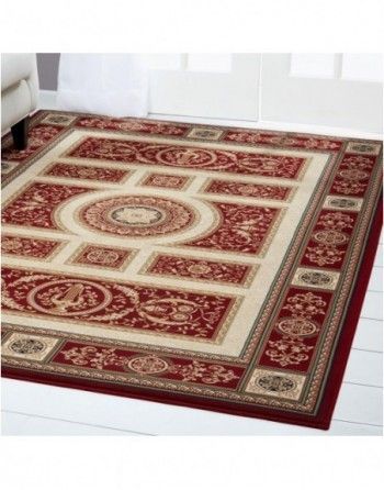 A red and white rug is sitting on a white floor