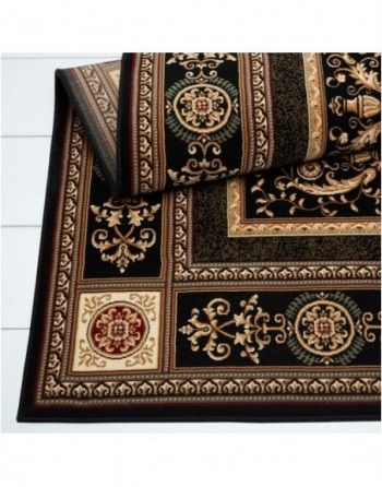 A black and gold rug with a floral design on it