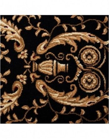 A black and gold rug with a floral pattern