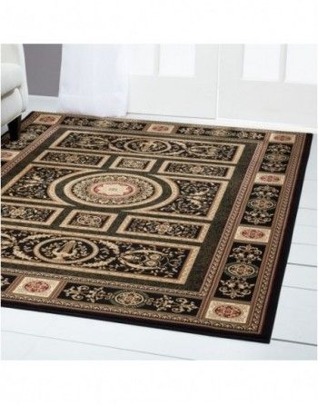 A rug is sitting on a white floor next to a couch.