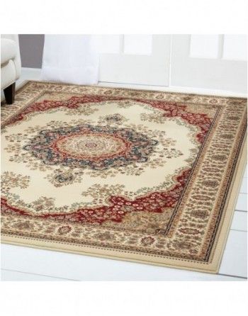 A rug is sitting on the floor in a living room next to a couch.