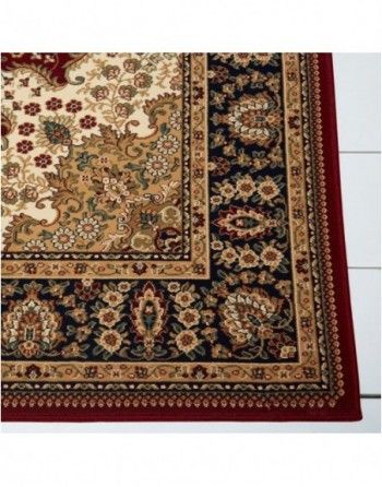 A rug with a floral pattern and a red border