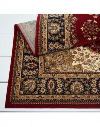 A red rug with a floral pattern on it