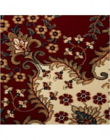 A red rug with flowers and leaves on it