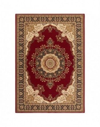 A red and gold rug with a circular design on it