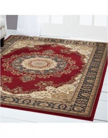 A red rug with a gold border is on a white floor