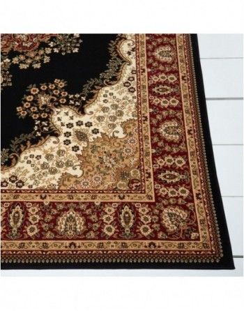 A black and red rug with a floral pattern on it