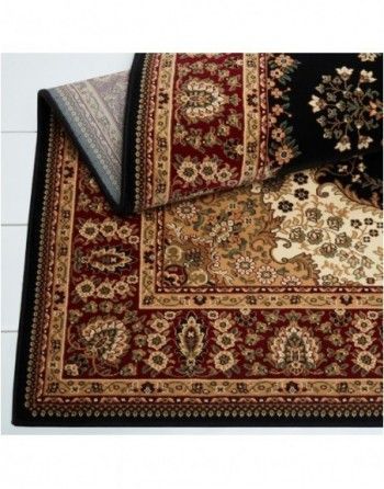 A rug with a floral pattern and a black border