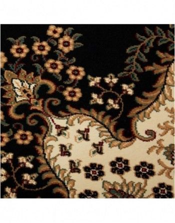 A black rug with flowers and leaves on it