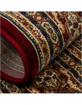 A close up of a rug with a red border.