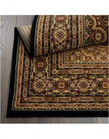 A close up of a rug on a wooden floor.