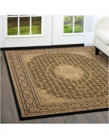 A rug is sitting on a wooden floor in a living room next to a couch.