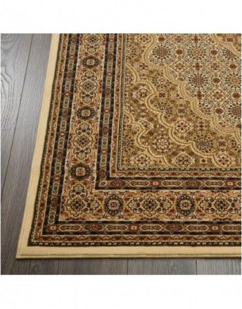 A rug with a floral pattern is sitting on a wooden floor.