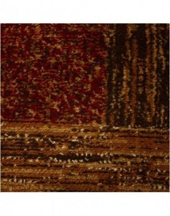 A close up of a rug with a red and brown pattern.