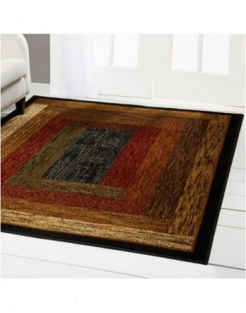 A rug in a living room with a couch in the background