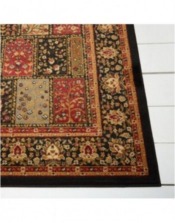 A rug with a black border is on a white floor