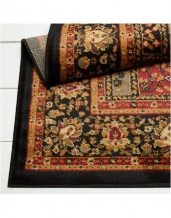 A black and red rug with a floral pattern on it