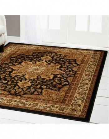 A rug is sitting on the floor in a living room next to a couch.