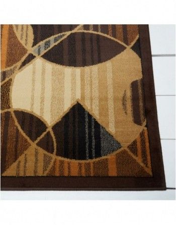 A brown and tan rug with a geometric pattern on it