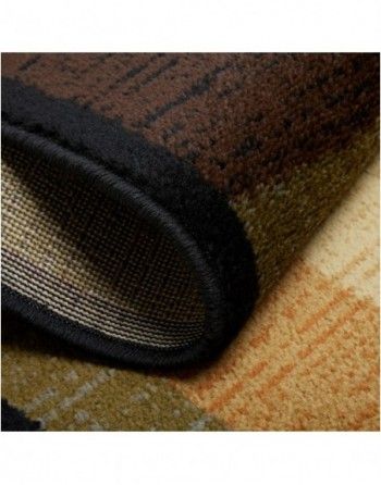 A close up of the bottom of a rug with a black border.