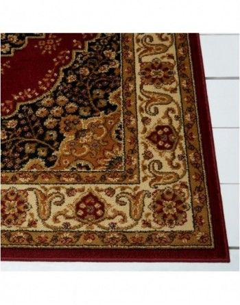 A close up of a rug with a red border