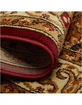 A close up of a rug with a red border