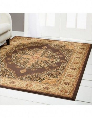 A rug is on the floor in a living room next to a chair