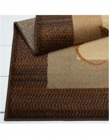 A brown and tan rug with a geometric pattern on it