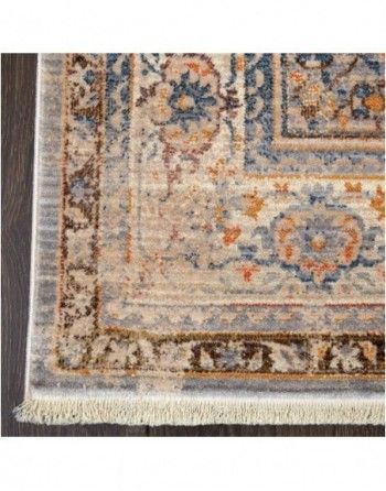 A close up of a rug on a wooden floor.