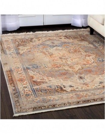 A rug is sitting on a wooden floor next to a couch.