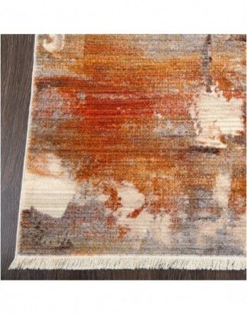 A rug with a painting on it is sitting on a wooden floor.