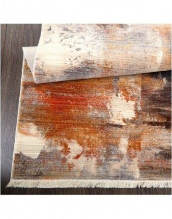 A rug with a painting on it is sitting on top of a wooden table.