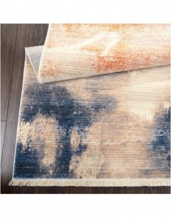 A rug is sitting on top of a wooden floor.