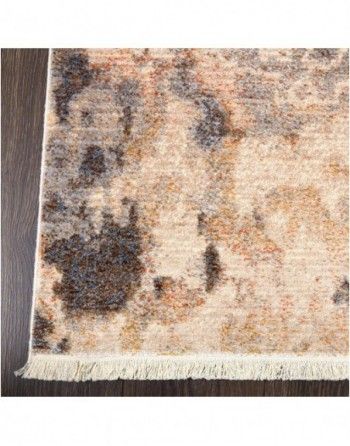 A close up of a rug on a wooden floor.