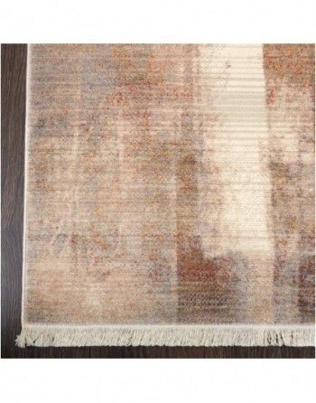 A rug is sitting on a wooden floor next to a window.