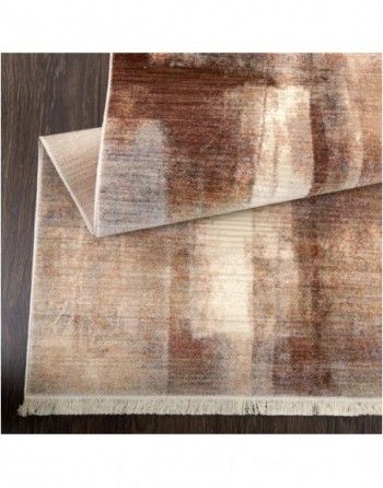 A brown and white rug is sitting on top of a wooden table.