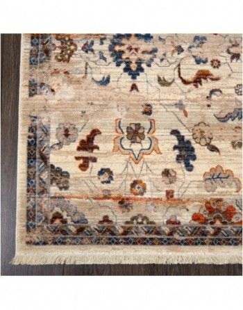 A rug with a floral pattern is sitting on a wooden floor.