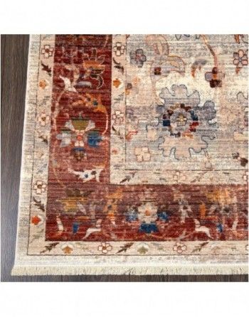 A rug with a floral pattern is sitting on a wooden floor.