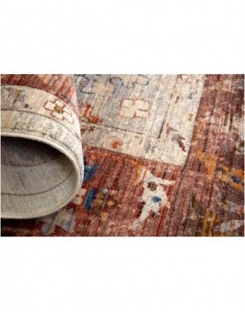 A close up of a rug rolled up on the floor.